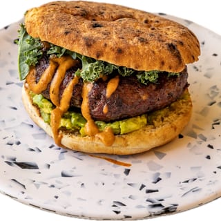 House Ground Chipotle Beef Burger, Avocado Hummus, Chipotle Tahini & Kale