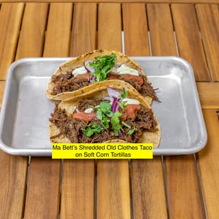 Ma Bett's Ropa Vieja Brisket Tacos, zhug mayo, roasted tomato salsa, pickled red onions, cilantro